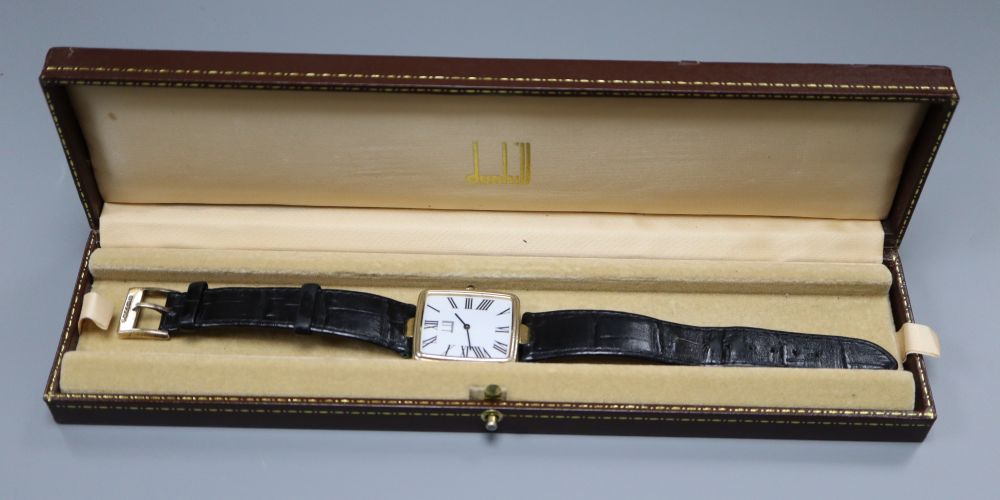 A gentlemans stylish modern silver gilt Dunhill quartz wrist watch, with rectangular Roman dial, on leather strap, with Dunhill buckle